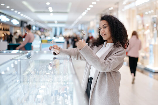 young woman choosing a piece of jewelry in a jewelry store.