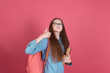 Little kid girl 13 years old isolated on pink background schoolgirl with backpack and books happy...