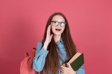 Little kid girl 13 years old isolated on pink background schoolgirl with backpack and books happy...