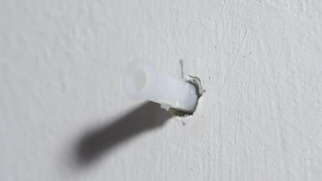 Score dowel with a hammer, tighten the screws on the wall with a screwdriver