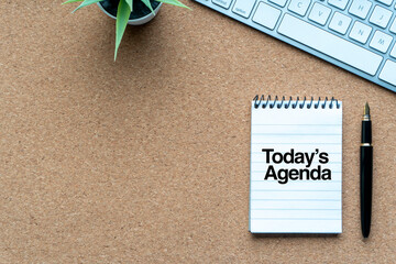 TODAYÕS AGENDA text with notepad, decorative plant, keyboard and fountain pen on wooden...