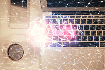 Double exposure of brain drawing hologram over topview work table background with computer. Concept of big data.