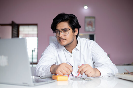 Student in  working With electronic circuit performing technical education project  