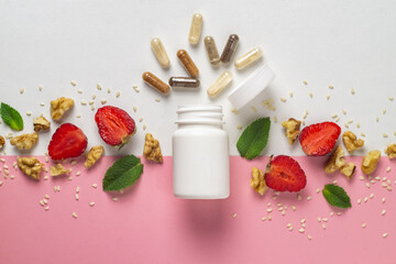 Various capsules with dietary supplements or vitamines in white plastic jar