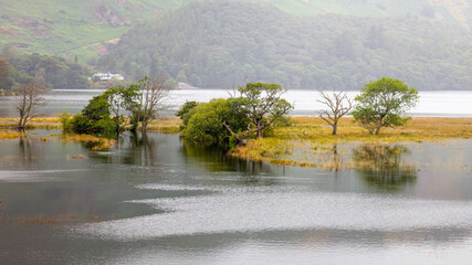 A landscape view of flooded land adjacent to Derwent Water, the Lake District, UK