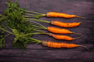 fresh carrots on a wooden table top view