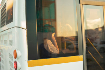 The girl sleeps outside the bus window. Woman in transport.
