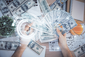 Multi exposure of technology drawing hologram and us dollars bills and man hands. Data concept