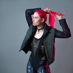 Futuristic fashion, a young bright and attractive woman with pink hair,