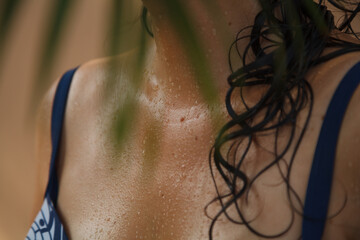 Water drops on body of woman in swimsuit - obrazy, fototapety, plakaty