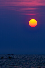 A picture of sunset and  fishing boat in the sea