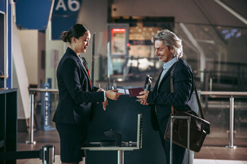 Business man traveling and doing check-in at the airport