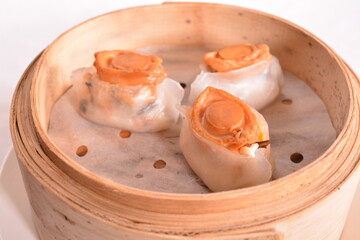steamed fresh seafood prawn pork meat crystal dumpling ball with mini abalone har gao in bamboo...