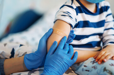 People vaccination concept for immunity health. Covid-19.  Children's doctor vaccinating little boy at home. Healthcare, coronavirus, prevention and immunize. - obrazy, fototapety, plakaty