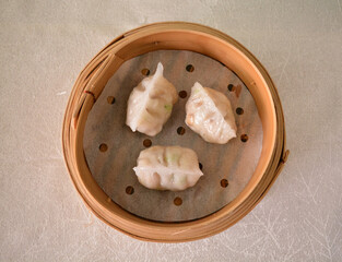 steamed fresh seafood prawn pork meat crystal vegetable dumpling ball har gao in bamboo basket Hong...