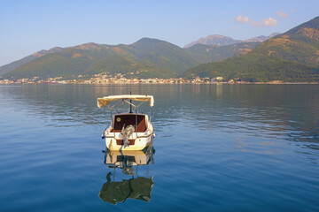 Summer Mediterranean landscape. Montenegro, Adriatic Sea. View of Kotor Bay near Tivat city. Fishing boat on the water