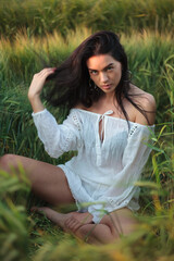 Fashion model in pink dress in field
