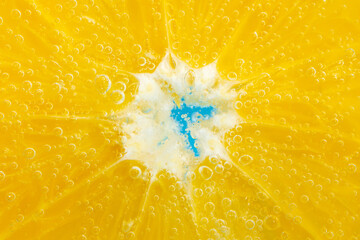 orange fruit in the water close-up macro. Refreshing grapefruit drink, cocktail. Slow motion