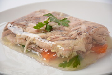 Home made aspic, jellied chicken meat with herbs and carrots. Traditional Russian dish 