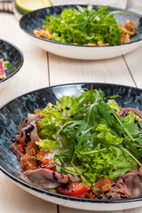 summer salad with roast beef, arugula and sun-dried tomatoes