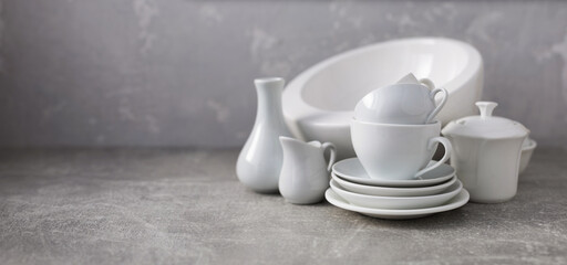 Empty crockery set or white ceramic dishes. White kitchen dishware and tableware on table