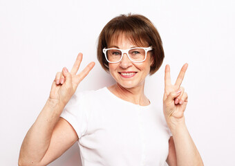 Old people, modern lifestyle, body language concept. Adorable mature wrinkled woman smiles broadly...