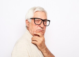portrait of senior man wearing glasses over white background