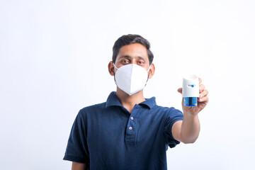 Young man holding mosquito repellent in hand.