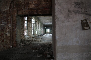 Fototapeta na wymiar Corridor with windows in old abandobed factory