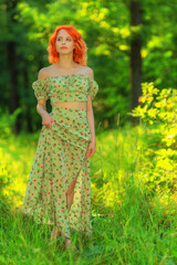 Woman in dress walking in summer forest - 445866269