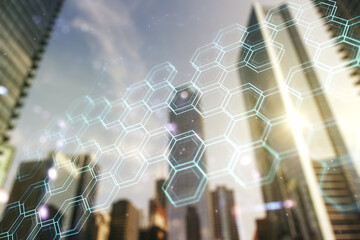 Double exposure of abstract virtual technology hologram with hexagon on modern skyscrapers background. Research and development software concept
