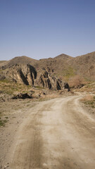 Offroad dirt road on an empty dry arid desert landscape