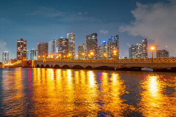 Fototapeta na wymiar City of Miami Florida, sunset panorama with business and residential buildings and bridge on Biscayne Bay. Skyline night view.