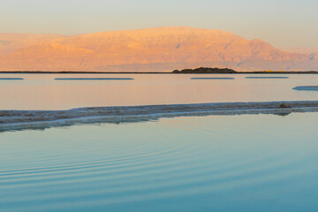 Sunset at the Dead Sea. Salt formations. Mountain range