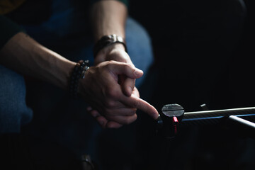 male hands on a dark background close up