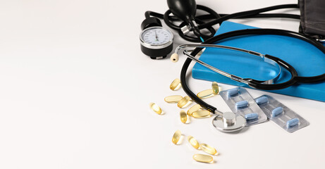 tonometer, device for measuring pressure, omega-3 capsules on a white background, lifestyle, medicine, baner, empty space for text