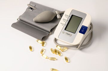tonometer, device for measuring pressure, omega-3 capsules on a white background, lifestyle