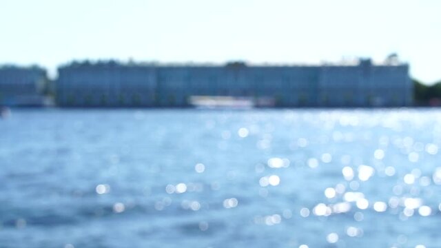 Slow motion bokeh background of sun playing on Neva river opposite the Hermitage