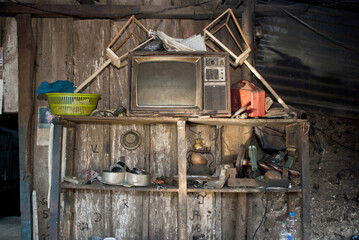 View of accumulated and disordered objects on an old wooden shelf