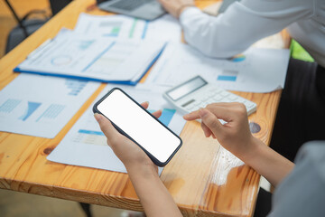 Cropped shot of professional businesswoman holding blank screen smartphone in a modern office room.