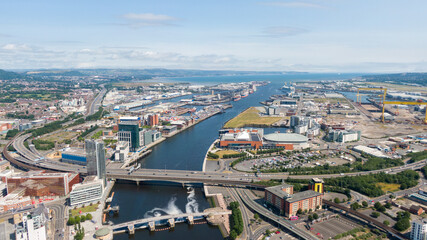 Obraz premium Aerial view on river and buildings in City center of Belfast Northern Ireland. Drone photo, high angle view of town