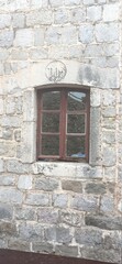 Fototapeta na wymiar Window in an old stone wall