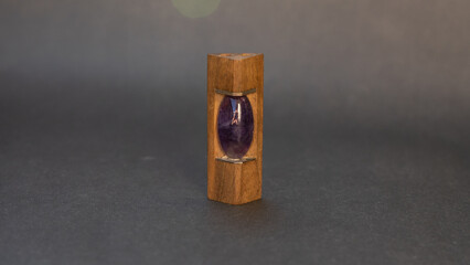 wooden pendant with steel inserts and purple stone