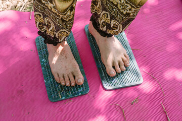 A person stands at sadhu boards. Yoga concentration practice. Ancient practices 