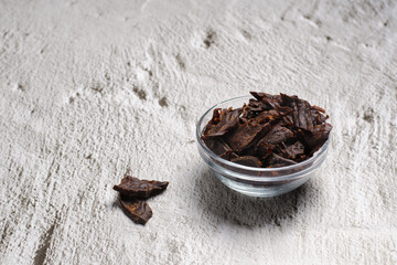Jerky meat on a concrete background. Dried beef. Glassware. Copy space. Close-up.
