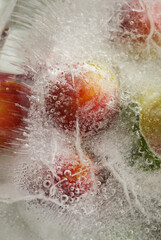 Ice texture with small round plums inside the layer of ice