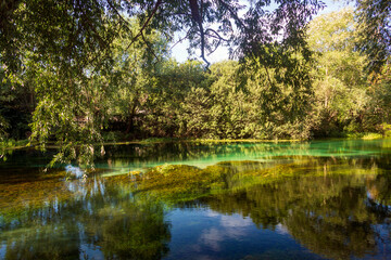 Fototapeta na wymiar On the banks of the river Tirino. Clear, transparent water. A beautiful landscape in the province of L'Aquila in Abruzzo
