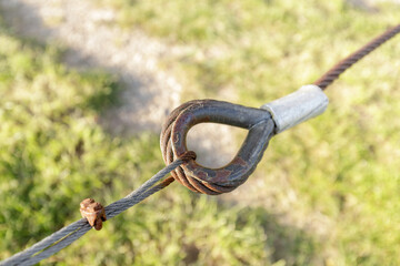 Fastening steel rusted rope cables  closeup. Flexible safety outdoors construction