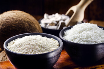organic coconut flour, with grated coconut in the background, culinary ingredients for fruit sweets