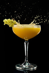Alcohol cocktail Daiquiri with mango. Mango margarita frappe with splash on black background. Copy Space.